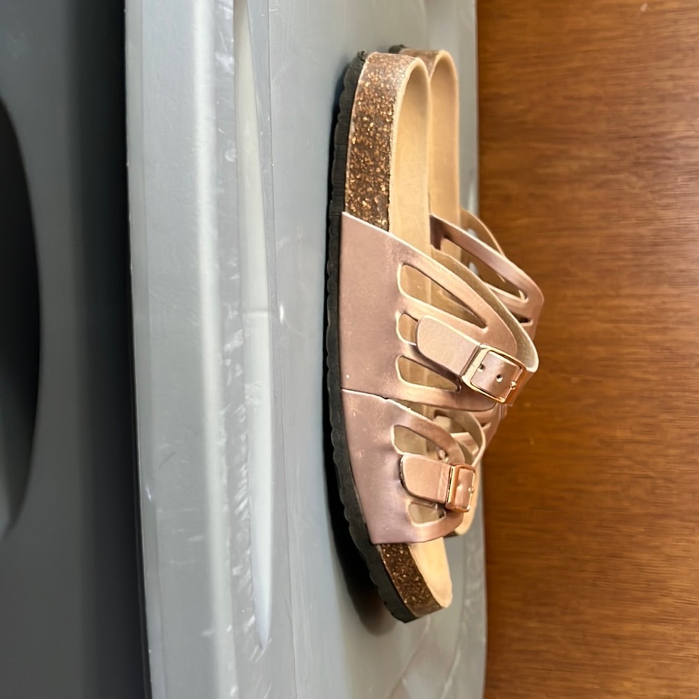 Women’s size 9 rose gold flat bed sandals.